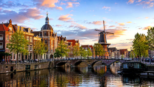 “Breedbeeldfoto van de historische grachten, bruggen en molen De Valk in Leiden, Nederland, bij zonsondergang – sfeervolle 8K landmarkfoto voor meubels herstofferen en meubelstoffering in Leiden.”